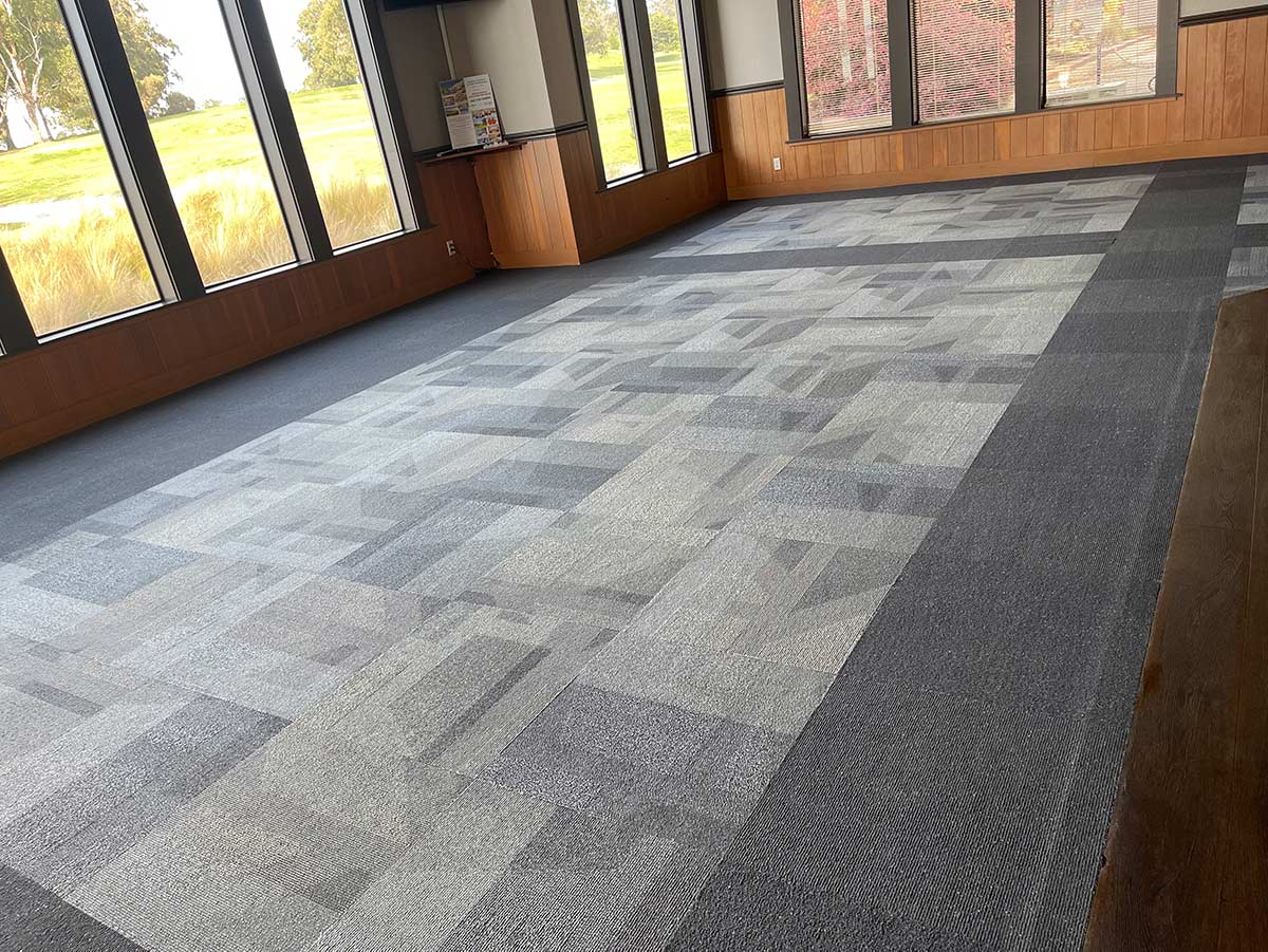 Large room with patterned tile floor and large windows overlooking a green lawn. Aladdin Magic Carpet Cleaning