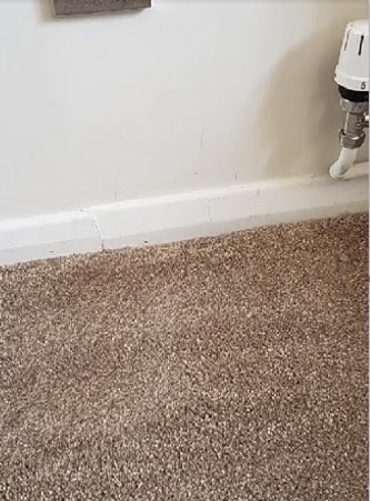 Carpet seam near wall and pipe